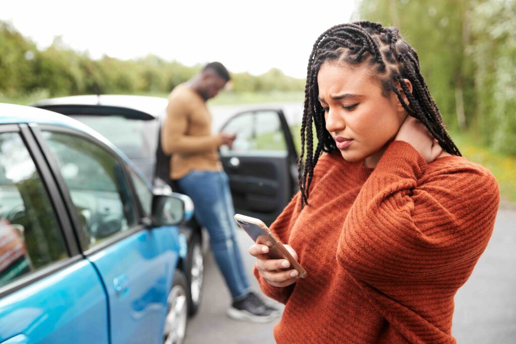 Female motorist involved in a car accident calling for help