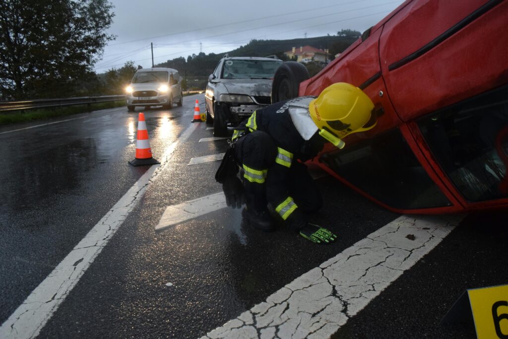 a rescuer checking the victims in a car accident on a highway