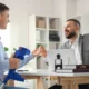 Male lawyer consulting man with crutches in office
