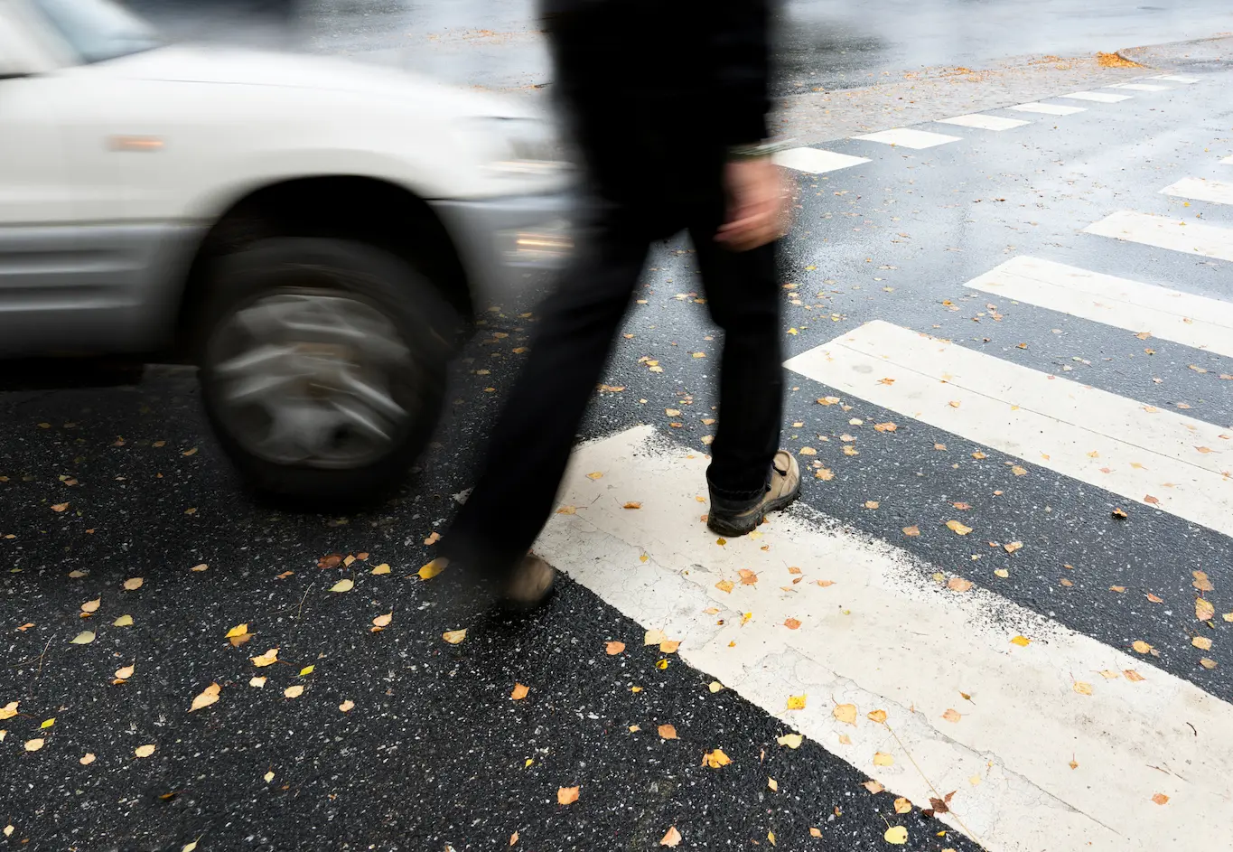 pedestrian in a crossing about to get hit by a car