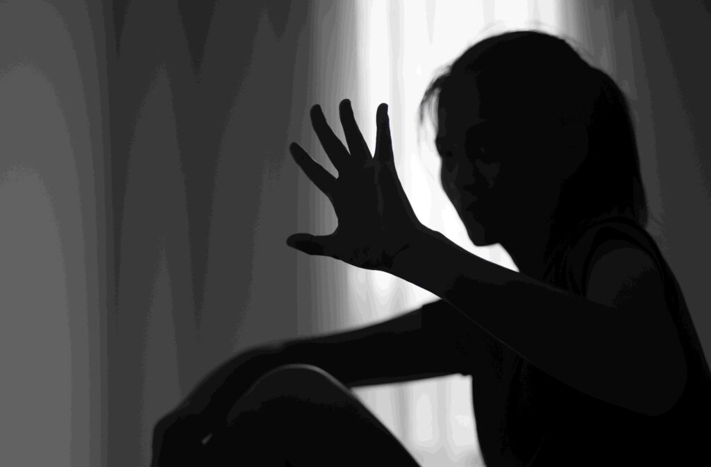 sexual assault victim making a stop hand gesture