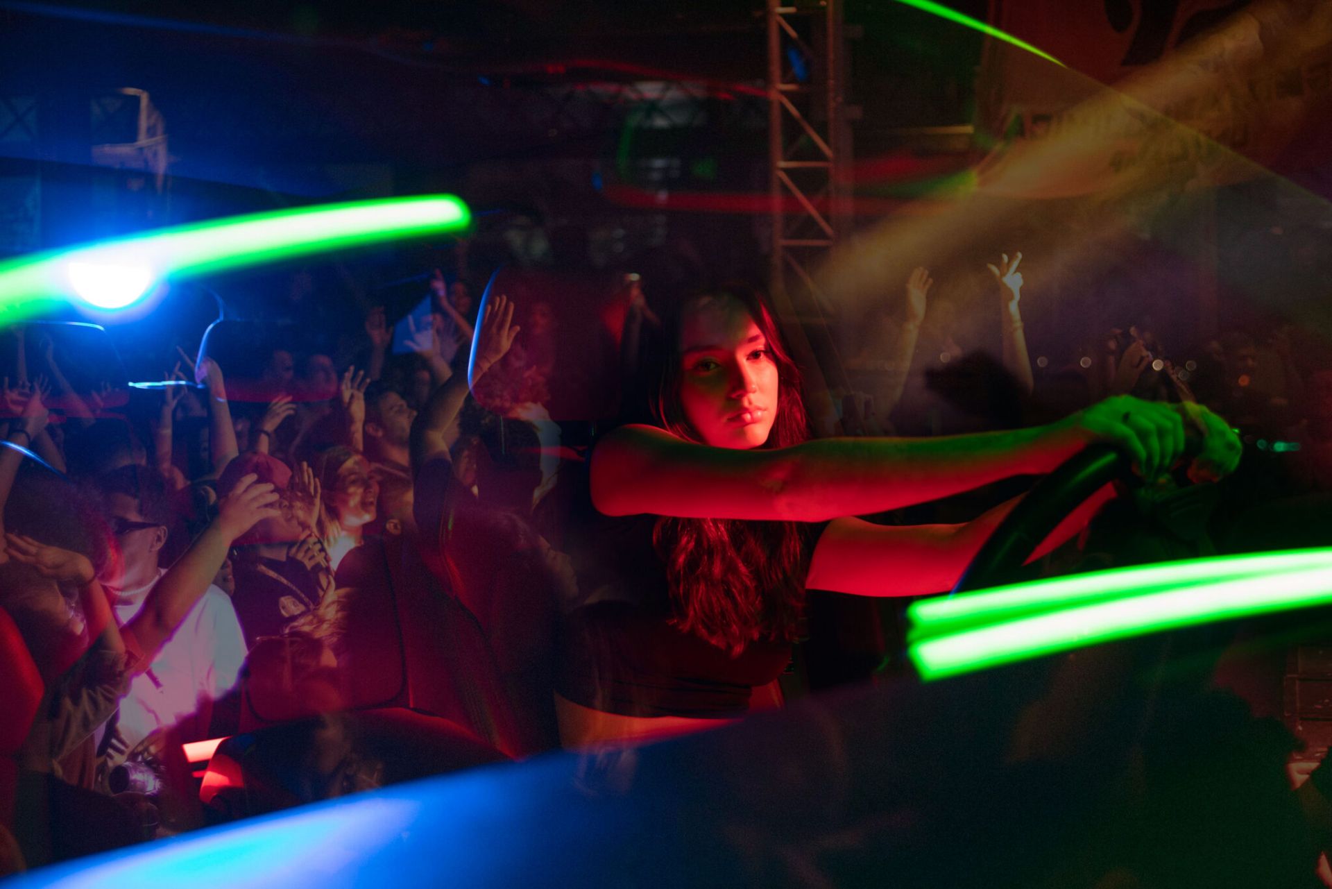A designated driver at the wheel with a concert crowd behind them.