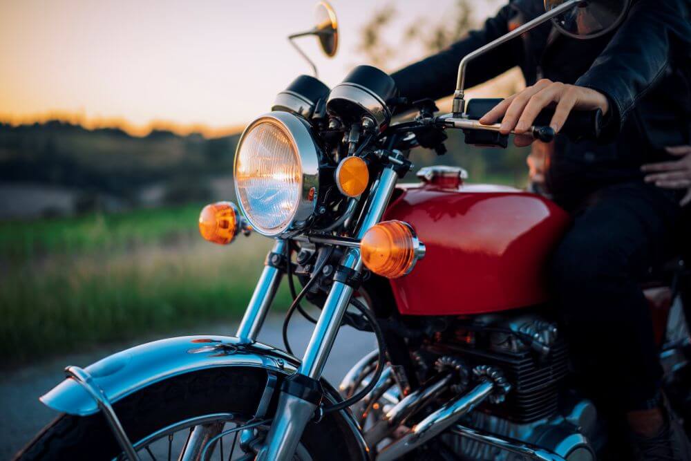 Man driving a motorcycle with a female passenger - CGH Injury Lawyers