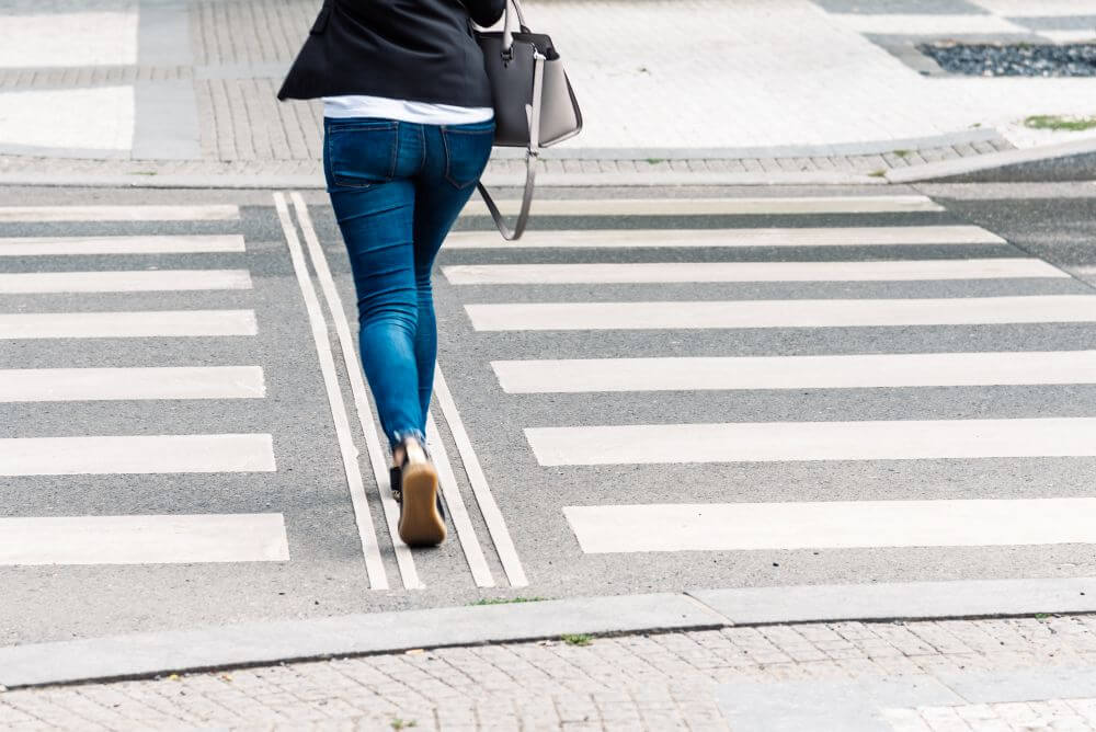 Woman walking on a crosswalk - CGH Injury Lawyers