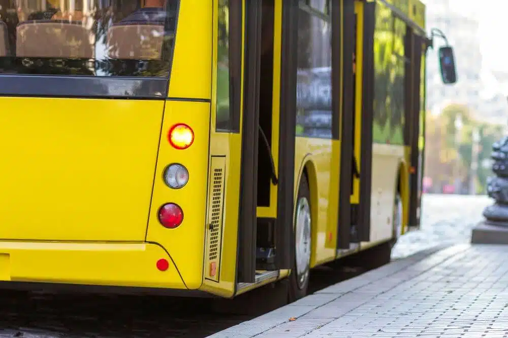 Yellow bus parking on the side of a street - CGH Injury Lawyers