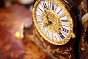 Golden grandfather clock showing a time of 12 midnight