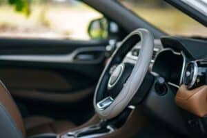 Interior of a car, with focus on the steering wheel