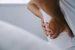 Man holding lower back in pain