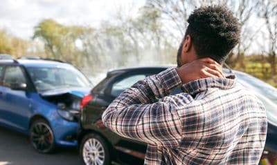 Man holds neck after a car accident