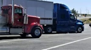 Parked red and blue sem trucks
